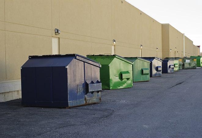 a compact construction dumpster being emptied by a waste disposal truck in Brentwood MD